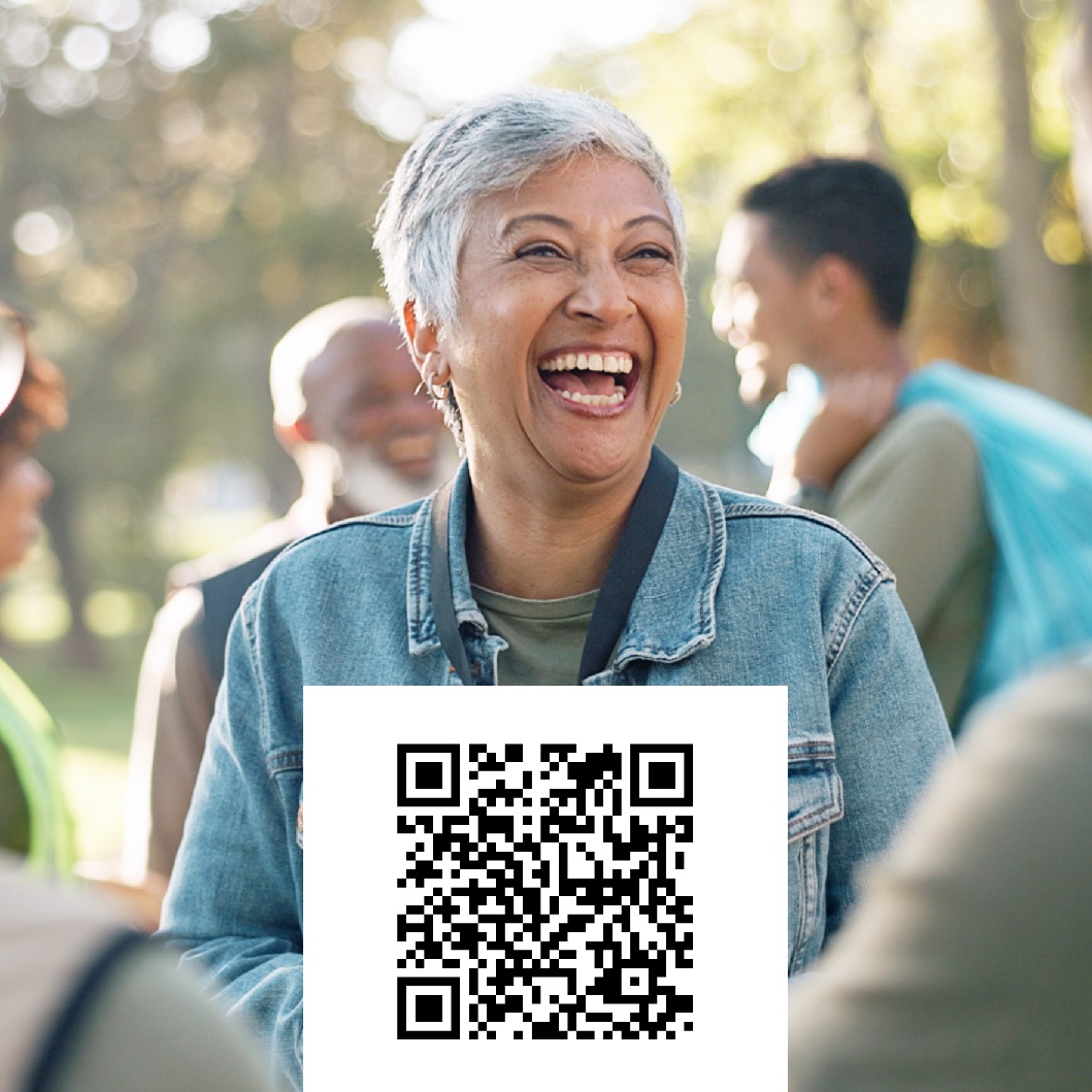 Image of woman smiling and happy with QR code that can be scanned