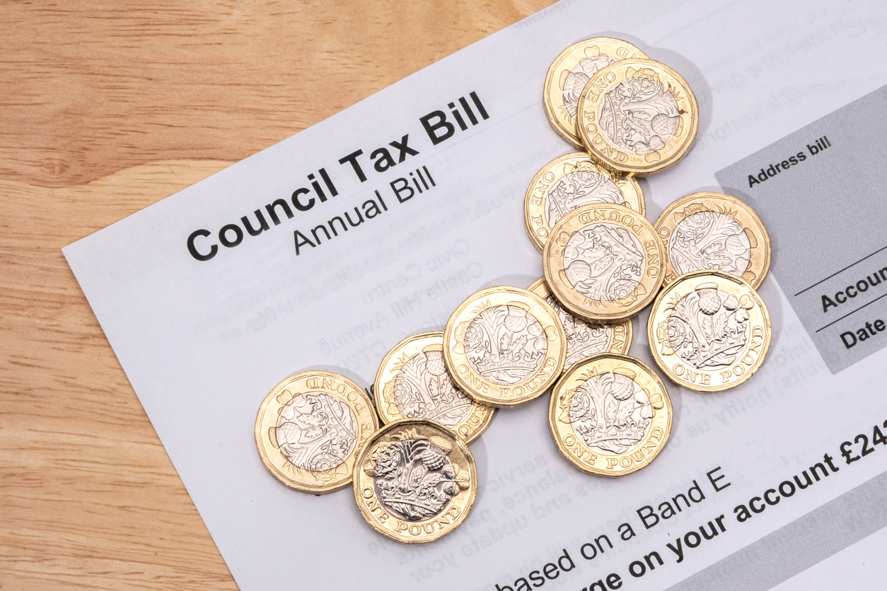 A council tax bill with pound coins.