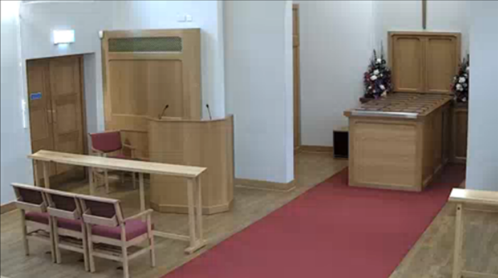 View of the crematorium via livestream, shows seats, podium etc