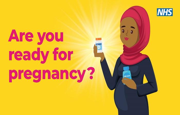 Pregnant lady with a bottle of multivitamins and folic acid.