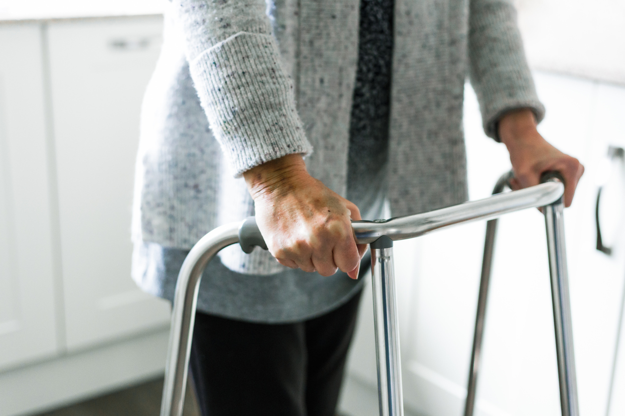 image of a woman using a walker
