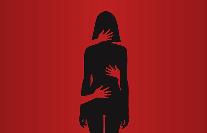 Silhouette of woman harassed by hands of man touching her