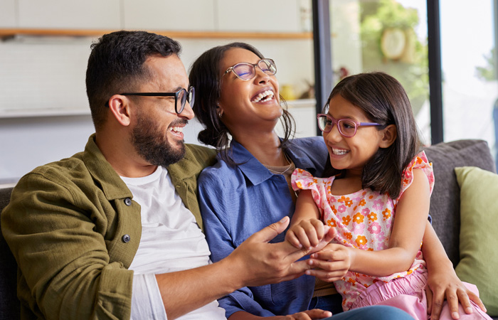 Parents playing with daughter at home